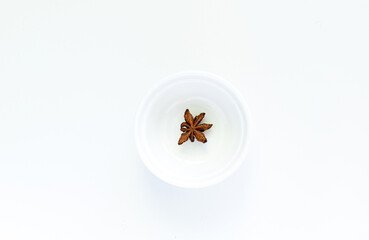 Anise on a white plate, on a white background. High quality photo
