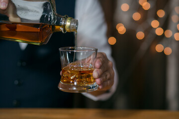 Barman pouring whiskey whiskey glass beautiful night
