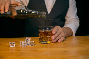 Barman pouring whiskey whiskey glass beautiful night