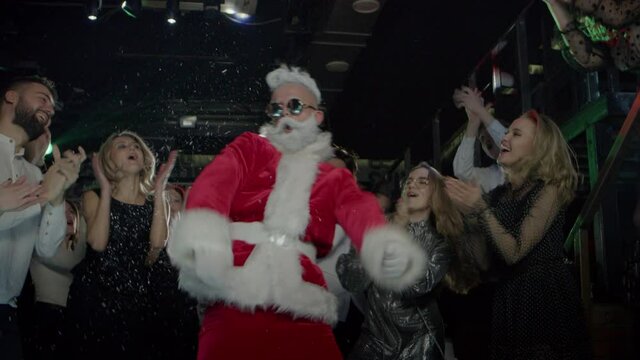Holiday party celebration on New Year Night of funny dancing people, Santa Claus
