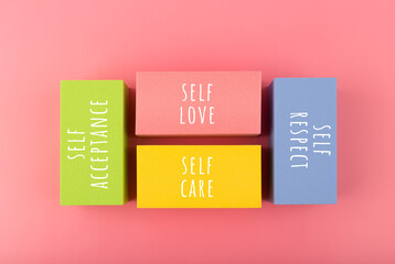 Self respect, acceptance, care and love written on multicolored rectangles. Mental health, self...