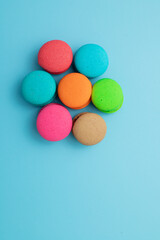 Fototapeta na wymiar macarons on a turquoise background Pastel Almond Cookies, Vintage 