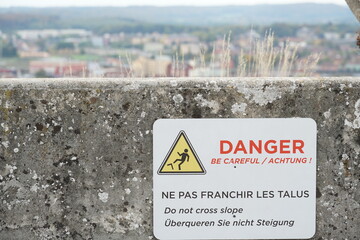 Warning sign to prevent tip over, overturn, in English, German and French language attached to the...