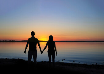 Sunset silhouette of a couple on the beach