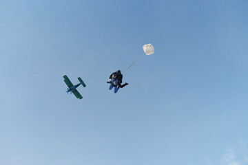 Skydiving. Tandem jump. An instructor and a girl are in the sky.