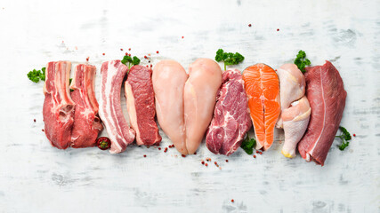 Banner. Raw meat steaks salmon, beef and chicken on a white wooden background. Organic food. Top view. - obrazy, fototapety, plakaty
