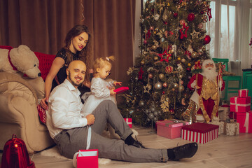 horizontal photo of happy family with daughter celebrate New year and Christmas together at home