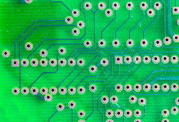 Printed green circuit board close-up. Electronic computer hardware technology macro photo. A digital motherboard chip. Microprocessor, transistors, semiconductor made from silicon. Technical science. 