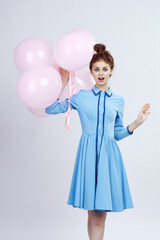 cheerful woman in a blue dress pink balloons holiday birthday