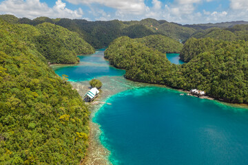 Tropical sea bay and lagoon, beach in Bucas Grande Island, Sohoton Cove. Philippines. Tropical landscape hill, clouds and mountains rocks with rainforest. Azure water of lagoon.