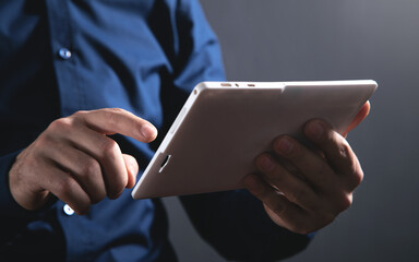 Businessman using white digital tablet.