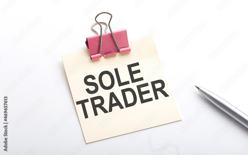 Poster sole trader text on the sticker with pen on white background
