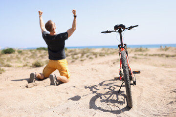 Male cyclist riding rejoicing of win competition