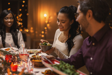 holidays, party and celebration concept - multiethnic group of happy friends having christmas dinner at home