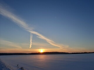 Naklejka na ściany i meble Winter landscape. Beautiful winter sunset. Sunset with beautiful clouds. Gorgeous sunset.