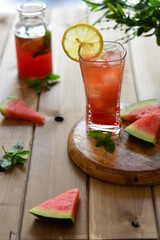 Photo of a watermelon mojito with lemon and mint and the use of reverse lighting