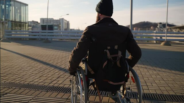 Handicapped man in wheelchair in the street with elevator