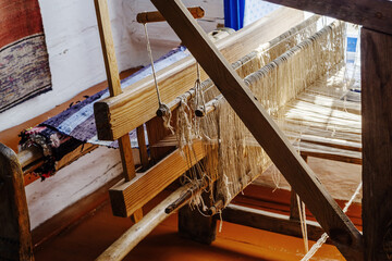 Old hand loom in the interior of a village house. Cossack estate in the village of Arkaim, Russia