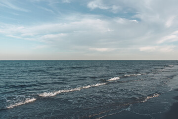 View of the blue sea and the beach line against the blue sky.