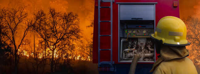 Firefighter extinguishing  wildfire with fire truck