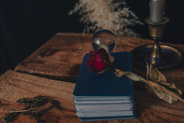 Dark wallpaper romantic scene of books, candles and mystery. Night of tarot card pulling.