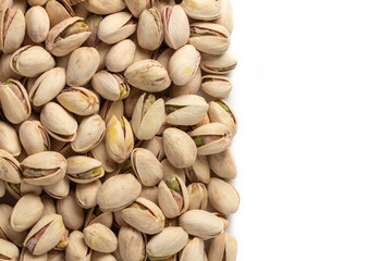Roasted and salted pistachios in shell on white background copy space