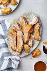 churros in with caramel and chocolate sauces