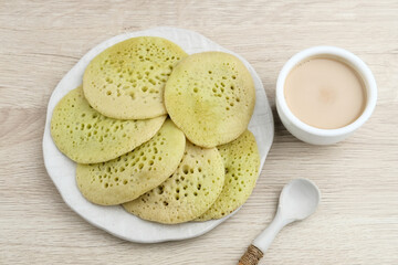 Serabi or Surabi,  Indonesian pancake made of flour, rice flour and coconut milk. Served with palm sugar sauce. Sweet and savory. Selective focus image.
