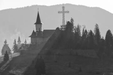 Black and white close up of monastery and cross on Tihuta Pass, Transylvania, Romania