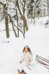 Fototapeta na wymiar Portrait of a girl walking in the winter outdoors. Playing with snow. children outdoor