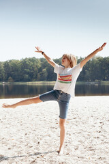 Beautiful teen girl rests on a sand beach