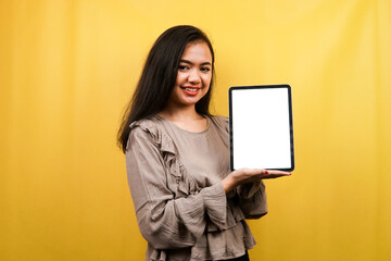 Beautiful young woman hands holding tablet with blank or white screen, presenting something, promoting product, cheerful and confident, advertisement, isolated