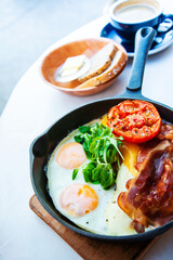 Grilled toasts served with beans, scrambled eggs and sausage for an English breakfast
