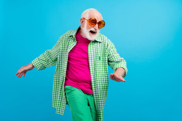 Photo of amazed excited cheerful old white haired grandpa dance look empty space summer outfit isolated on blue color background