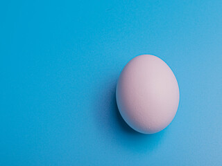 white egg on blue background