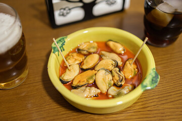 Close-up of pickled mussels in a bowl. Traditional Spanish appetizer