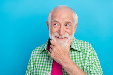 Photo of positive happy minded old man look empty space creative plan isolated on pastel blue color background