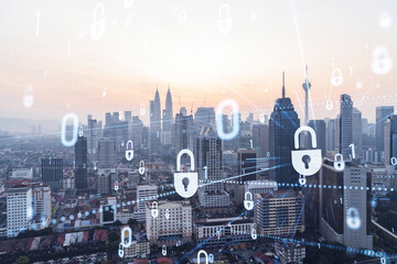 Padlock hologram on sunset panoramic cityscape of Kuala Lumpur, Malaysia, Asia. The concept of cyber security intelligence in KL. Multi exposure.