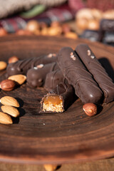 Chocolate with caramel and nuts. Copy space. Close-up. Soft focus background.