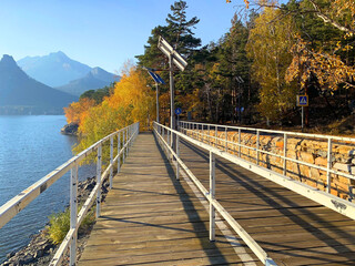 Obraz premium Burabay national Park with kokshe mount and lake. Beautiful brich forest in autumn time during day. Wooden walking bridge in a national park - Kazakhstan.