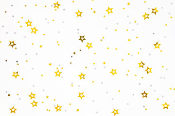 Gold and silver stars confetti on a white background. Festive concept.