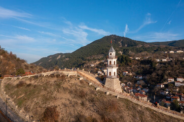 The Victory Tower (Zafer Kulesi) with the traditional houses in the background. Goynuk, Bolu, Turkey. Shooting with drone
