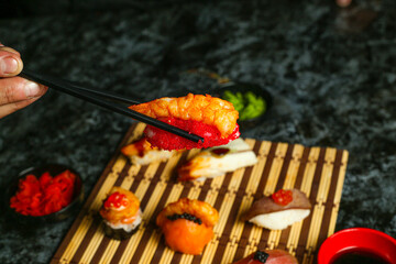 Traditional delicious fresh sushi roll set on a black background