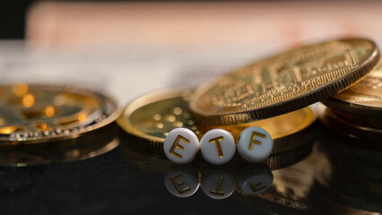 Bitcoin coin with ETF text Put on  wooden floor, Concept Entering the Digital Money Fund.