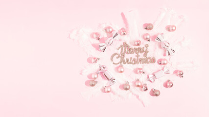 Modern luxury Christmas poster with shiny pink decorations on a pink background. Christmas invitation, background. Creative design greeting card. Top view.