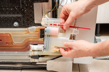 A man repairs a dishwasher