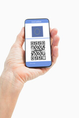 Man holding smartphone with covid 19 vaccine passport