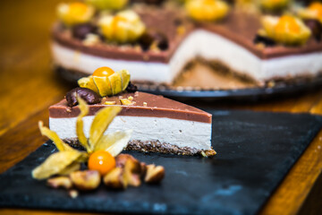 Light delicious yogurt cheesecake with physalis, nut and chestnuts  . Close up