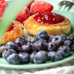 Cheesecakes with raspberry jam, berries, served with a cup of tea, cheesecakes

