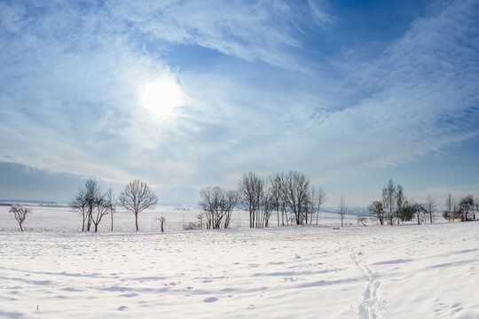 Winterlandschaft Schneebedecktes Skigebiet an kaltem Sonnentag Entspannung im Winterurlaub mit blauem Himmel und frostigen Bäumen